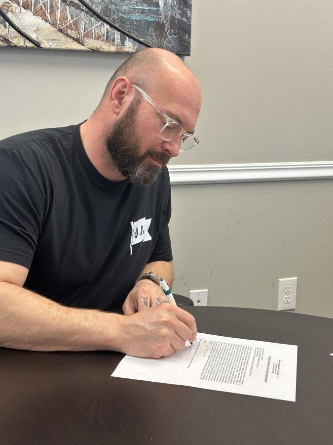 Signing closing paperwork at the title company