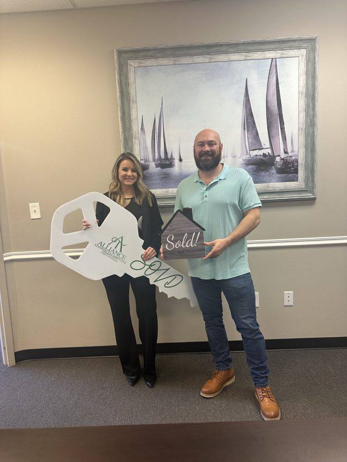 Clients with a SOLD key and a Sold! sign at the title office