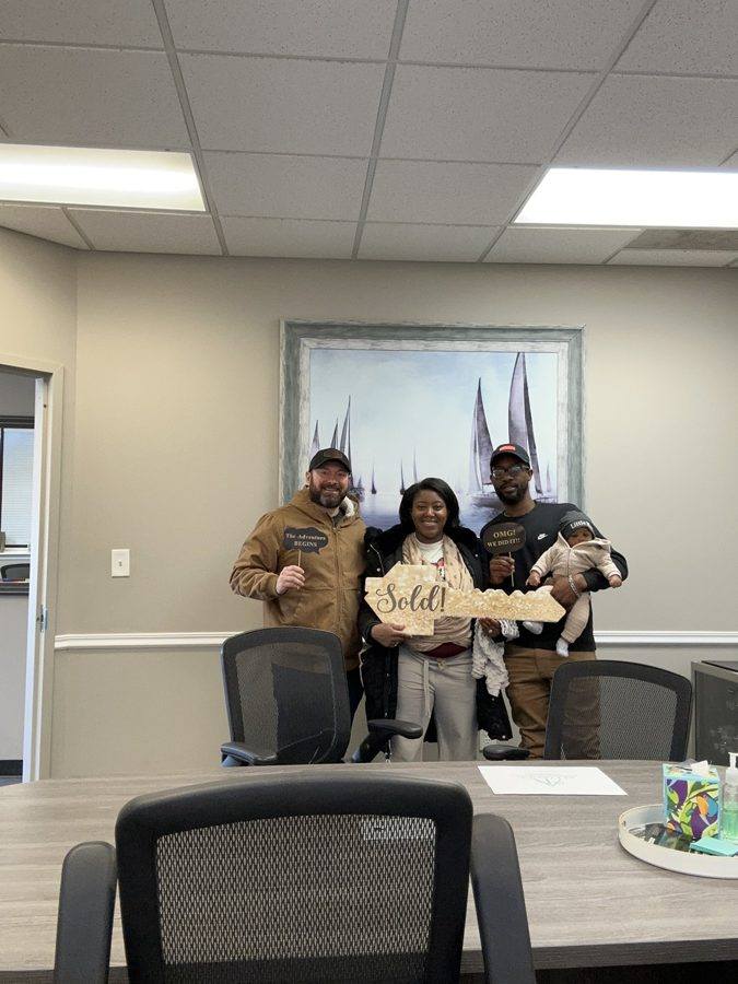 A family with their baby at the closing table