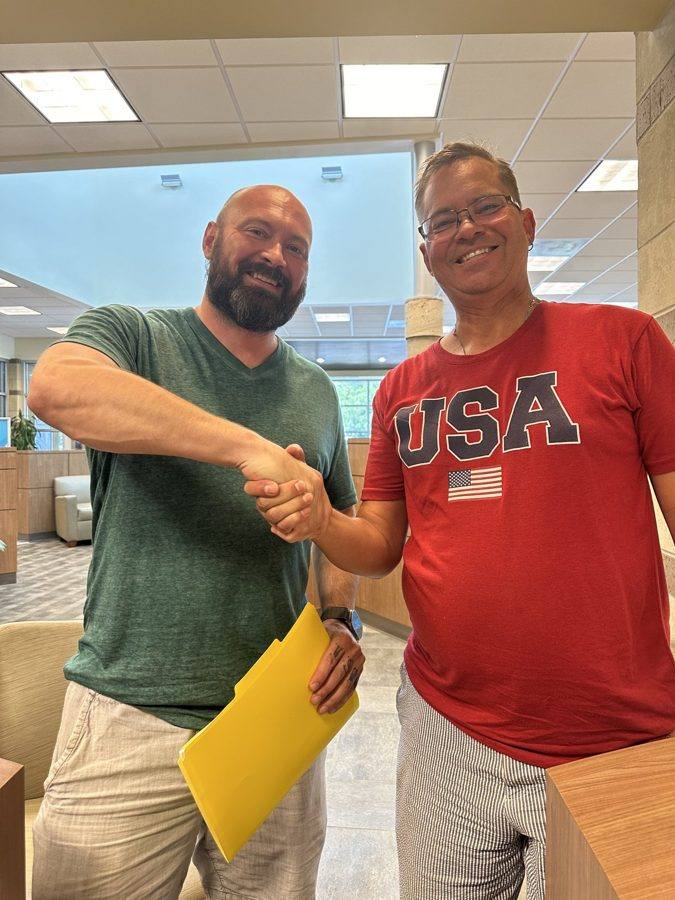A KC Home Offers team member shaking hands with a client