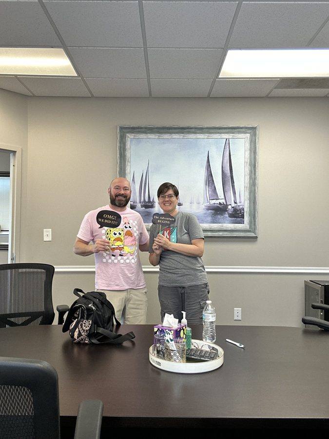 Two clients with celebration props at their closing