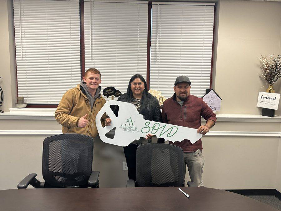 Three clients celebrating a closing with the SOLD key